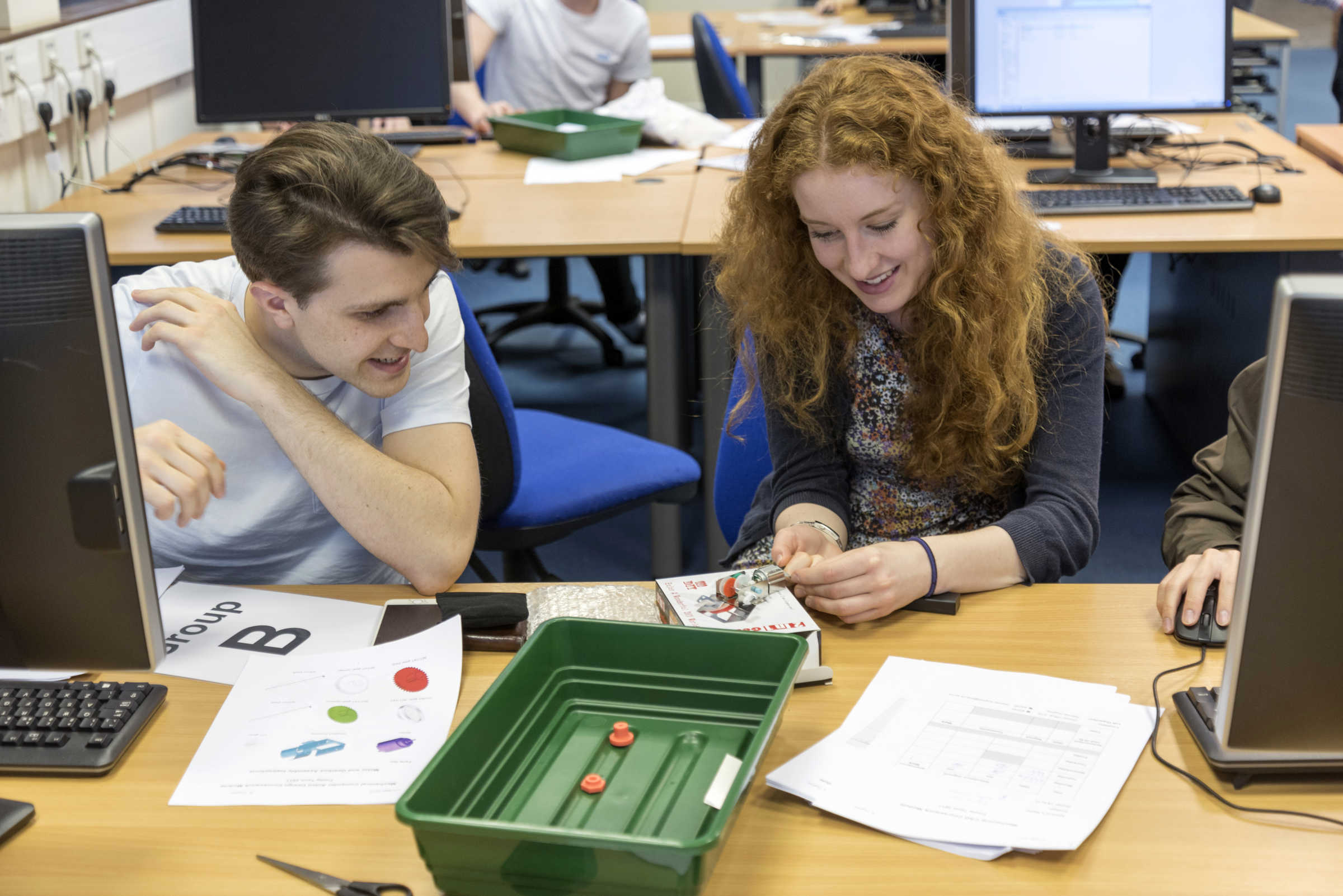 Students at computer desk working on project together